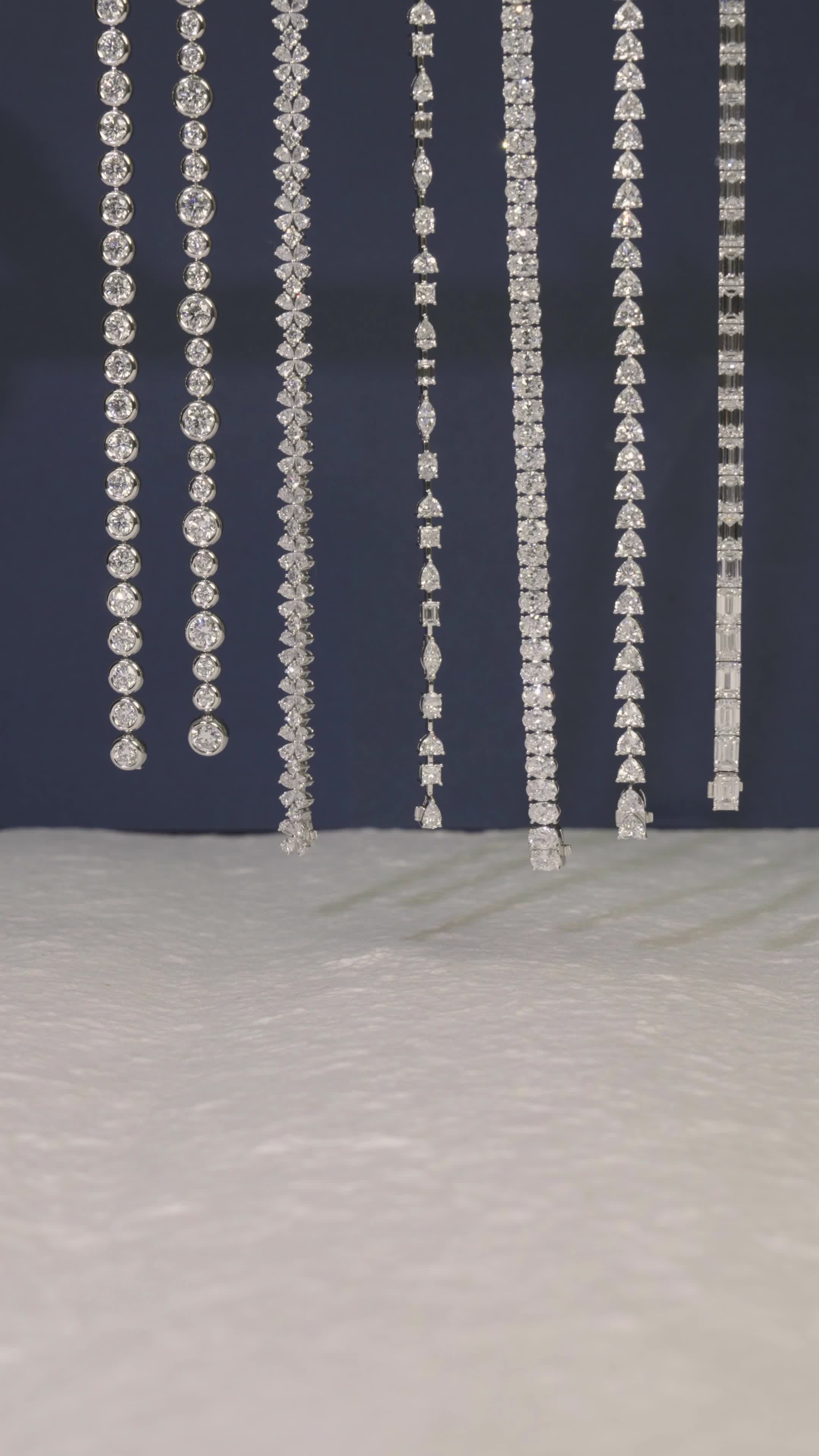 Lab-grown diamond jewelry arranged against a deep blue backdrop